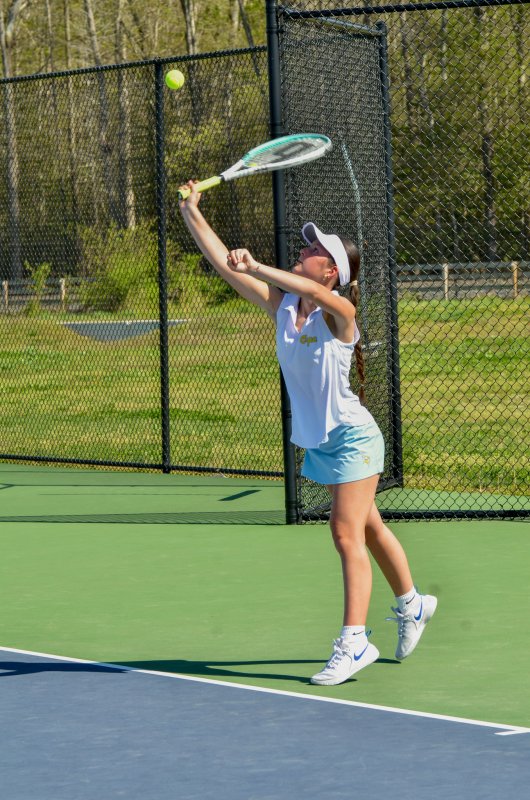 Cape junior Courtney Kosc serves the ball in first doubles.