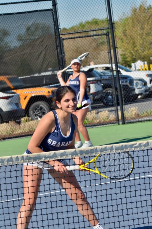 Always with a smile, no matter the circumstance, Sussex Academy’s Gia Berberian waits for Emma Feagans to serve the ball.