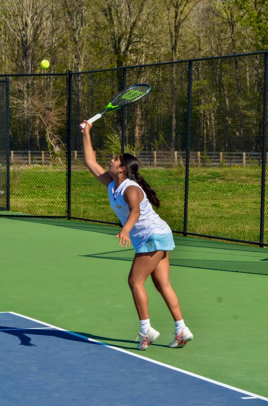 Vikings freshman Riti Patel serves the ball in first doubles.