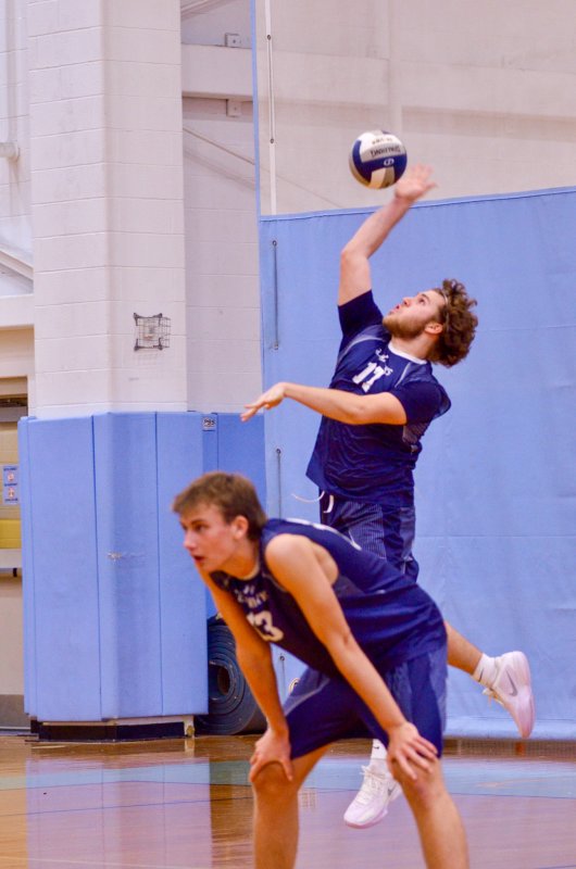 Sussex Academy senior Owen Schrader serves the ball.