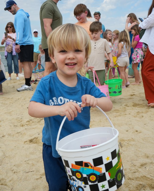Carter Crist holds up his Easter egg bucket with a smile.