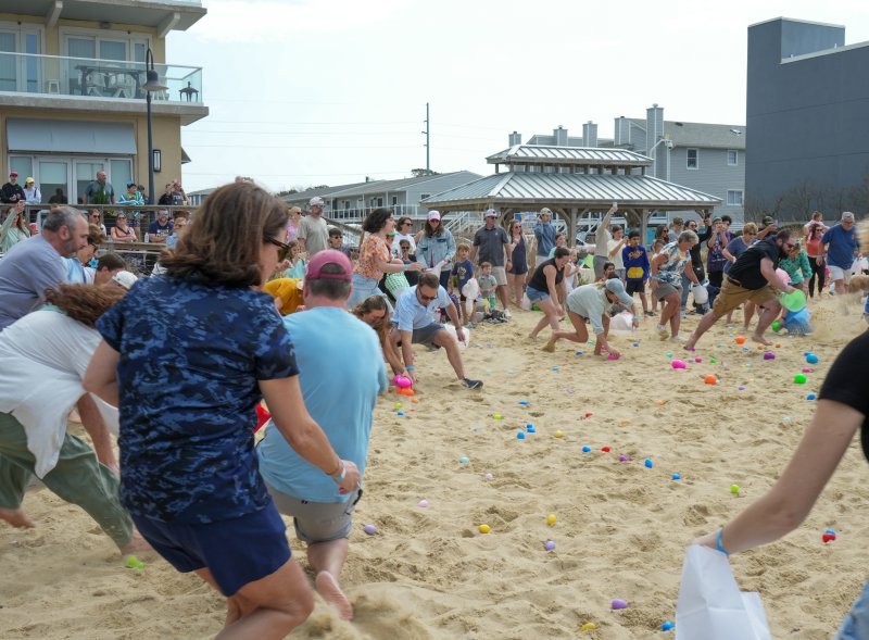 Participants in the adult age group race to grab as many eggs as they can.