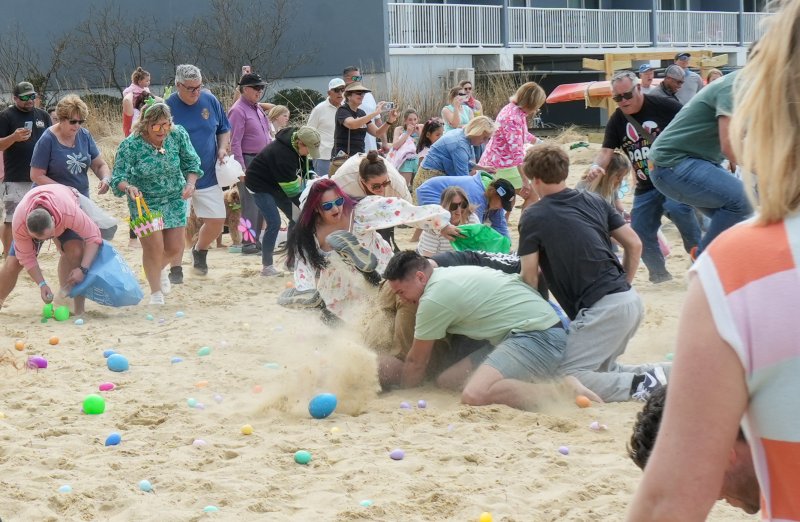Sand flies as participants in the adult age group scramble for eggs.