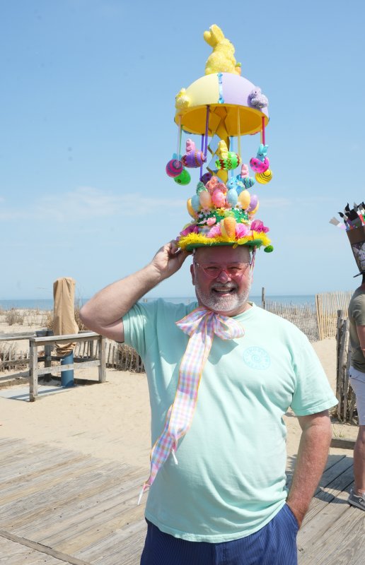 Ken Smith displays his double-decker Easter bonnet. He designed it to be able to rotate like a carousel.