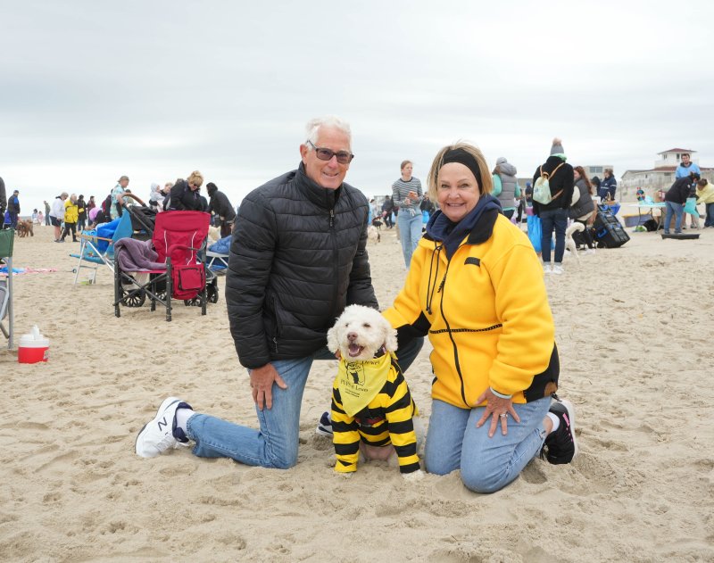 The Zipplers traveled from Virginia to attend their third Doodles in Dewey event, enjoying a doodle romp on the beach at McKinley Avenue in Dewey Beach April 25. Shown are Blaine Zippler, dog Dori and Liz Zippler. ELLEN MCINTYRE PHOTO