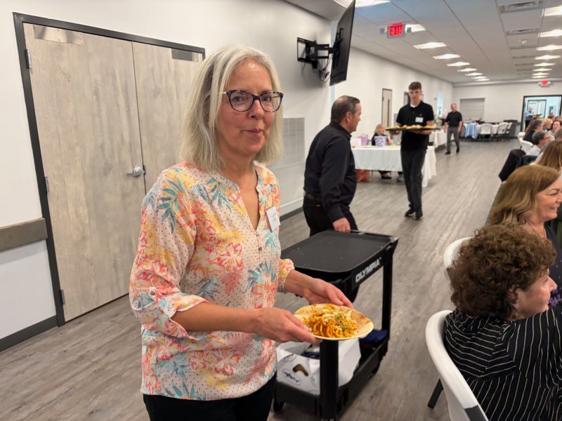 Each dish was served by pantry volunteers such as Linda Walters, shown serving chef Hari Cameron’s carrot and bacon ragu pasta. RYAN MAVITY PHOTOS