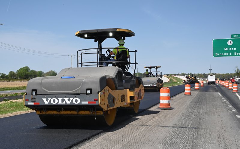 Crews pave Route 1 just south of the new bridge over Route 16 April 15, the day the bridge opened to traffic. NICK ROTH PHOTO